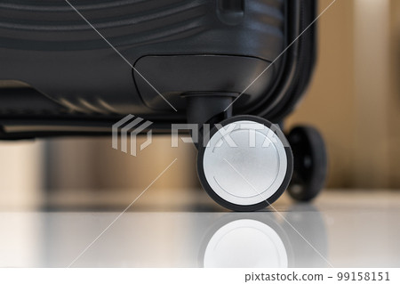 Close-up of black plastic travel carry-on suitcase on wheels 99158151