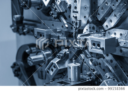 Close up scene the coil spring machine in light blue. Close up scene the coil spring machine in light blue. 99158366