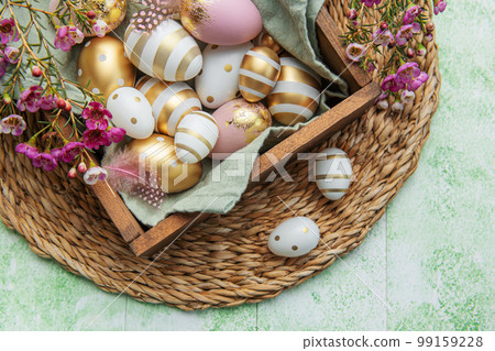 Easter decor. Colored Easter eggs in a wooden box on the table. Easter decor. Colored Easter eggs in a wooden box on the table. 99159228