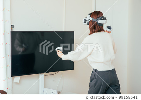 A woman enjoying a VR game Virtual 99159541