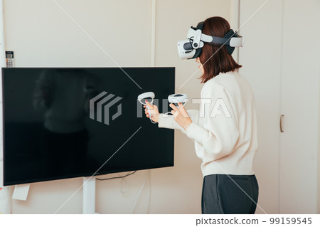 A woman enjoying a VR game Virtual 99159545