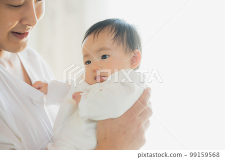 Papa holding a baby Papa holding a baby 99159568