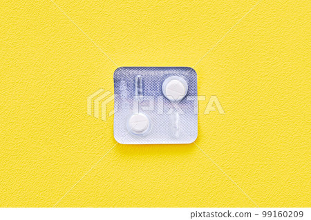 Anthelmintic tablets over yellow background 99160209