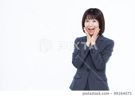 A business woman in her thirties who is surprised with a smile 99164075