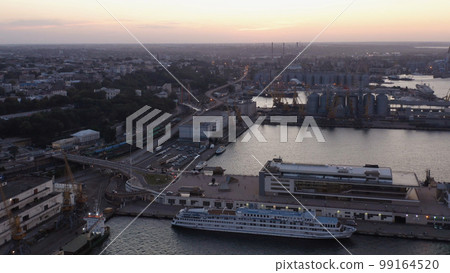 View from drone of urban city scape with sea port. Evening twilight sky. View from drone of urban city scape with sea port. Evening twilight sky. 99164520