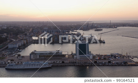Evening urban city scape with sea port. Odessa hotel and cruise ship. 99164521