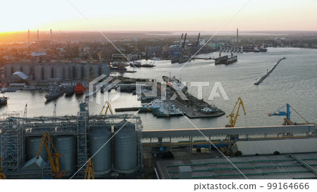 Sea port with cranes and terminals. Evening sunset light. 99164666