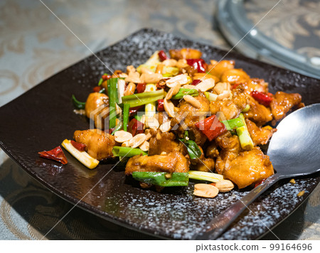 Kung Pao chicken on black plate Kung Pao chicken on black plate 99164696