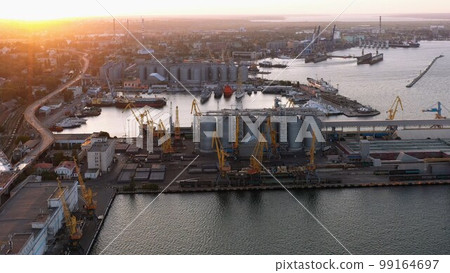 Aerial view of urban scape and sea port infrastructure. Evening sunset light. Aerial view of urban scape and sea port infrastructure. Evening sunset light. 99164697