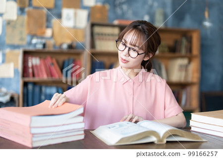 A young woman reading A young woman reading 99166257