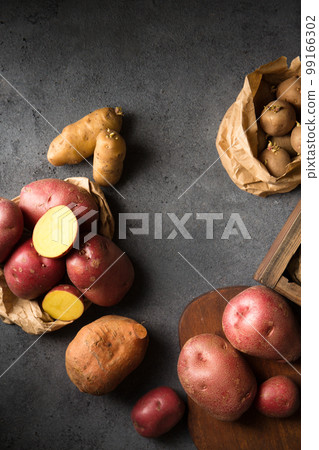 Germination of sprouts on potatoes, top view Germination of sprouts on potatoes, top view 99166302