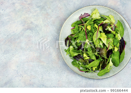 Fresh salad with mixed greens, space for text Fresh salad with mixed greens, space for text 99166444