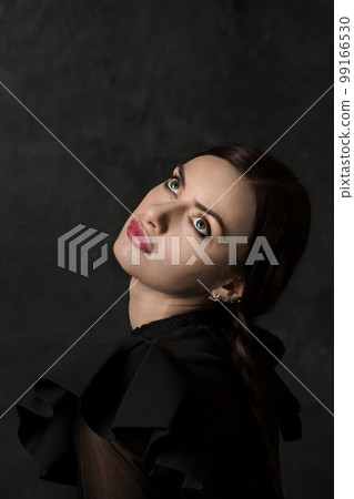 Beautiful woman with pigtails looks up 99166530