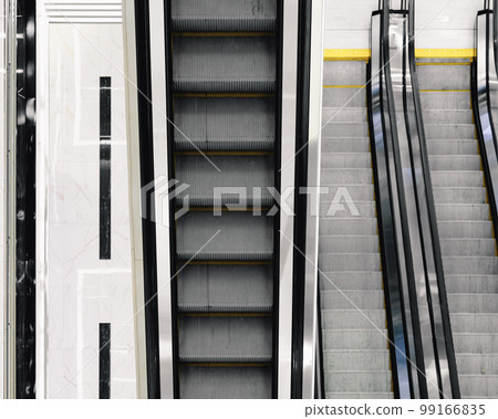 Selective focus on the stairs of an electric escalator. 99166835