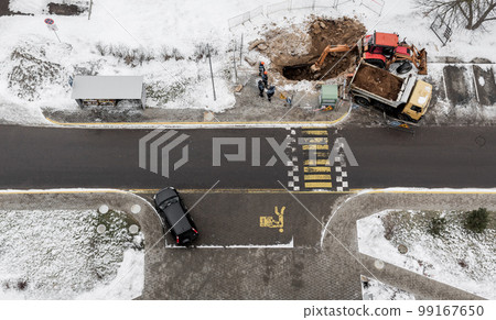 Heavy construction equipment during excavation at construction site 99167650