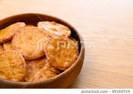 Baked senbei rice crackers served in a wooden bowl, traditional sweets Baked senbei rice crackers served in a wooden bowl, traditional sweets 99168559