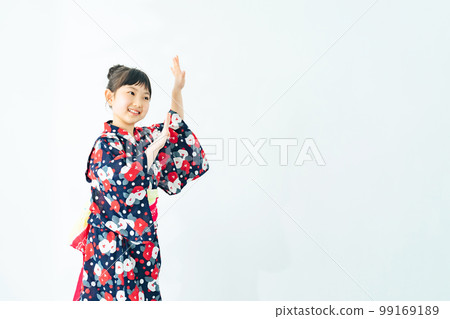 A girl wearing a yukata and dancing Bon Odori 99169189