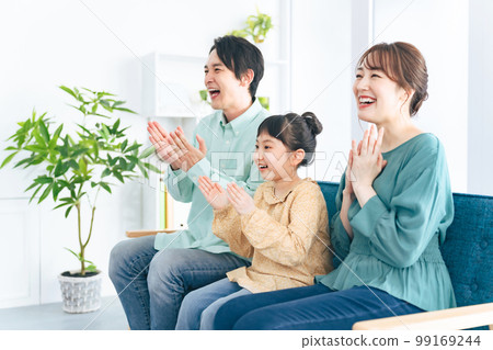 Parents and children excited to watch TV Parents and children excited to watch TV 99169244