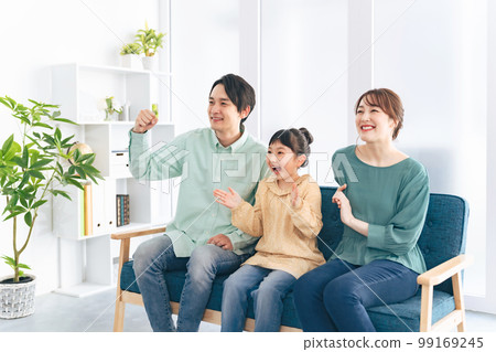 Parents and children excited to watch TV 99169245