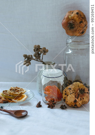 Vertical shot of pomegranate, lemon slices and aromatic herbs for a relaxing aromatherapy session at home 99169451