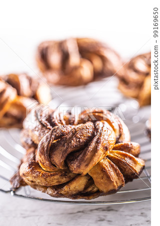 Freshly baked, caramel-cinnamon buns on the kitchen grill 99169650