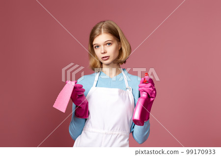 frowning woman cleaner apron with cleaning rag and detergent sprayer frowning woman cleaner apron with cleaning rag and detergent sprayer 99170933