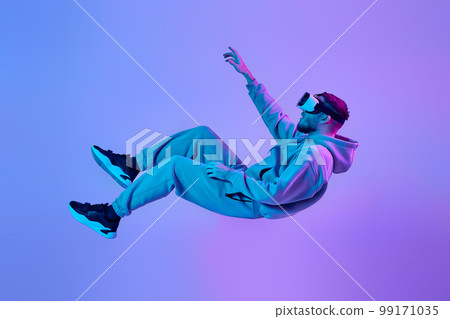 man using virtual reality glasses and playing video games man using virtual reality glasses and playing video games 99171035