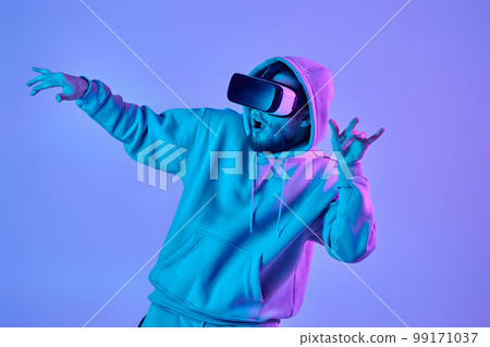 man using virtual reality glasses and playing video games man using virtual reality glasses and playing video games 99171037