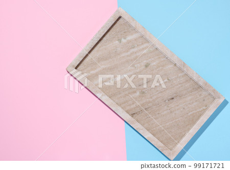 Empty beige rectangular marble plate on a blue pink background Empty beige rectangular marble plate on a blue pink background 99171721