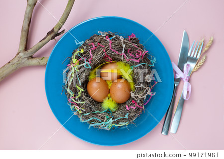 nest with eggs on blue plate on pink. Happy Easter. Stylish flat lay. Natural eggs spring nest with eggs on blue plate on pink. Happy Easter. Stylish flat lay. Natural eggs spring 99171981
