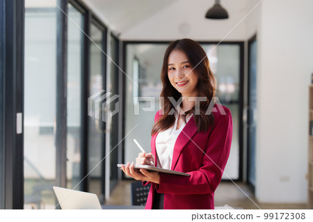 Beautiful asian business woman working on a laptop at office. Financial analysis and tax concept Beautiful asian business woman working on a laptop at office. Financial analysis and tax concept 99172308