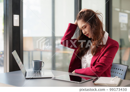 Stressed Business woman checking budget of company, taxes, bank account balance and calculating expenses at office Stressed Business woman checking budget of company, taxes, bank account balance and calculating expenses at office 99173430