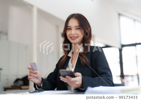 Woman makes a purchase on the smart phone with credit card, online payment, shopping online, e-commerce, internet banking concept 99173433