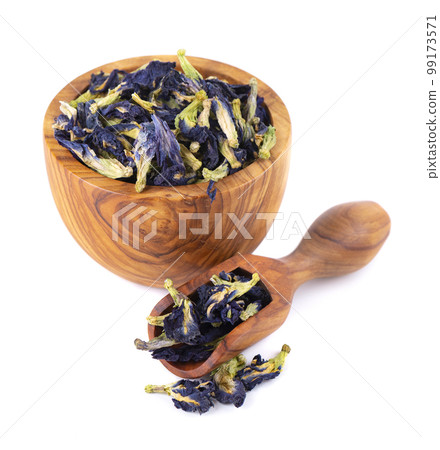Butterfly pea flowers in wooden bowl and spoon, isolated on white background. Blue herbal tea. Clitoria Ternatea. Butterfly pea flowers in wooden bowl and spoon, isolated on white background. Blue herbal tea. Clitoria Ternatea. 99173571