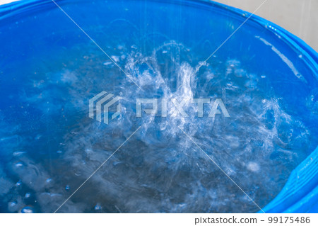 rainwater in a barrel in front of the house 99175486