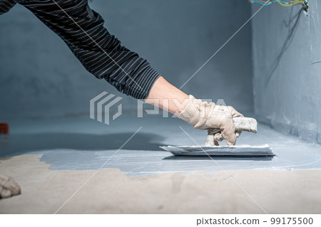 manual work with bathroom waterproofing using a trowel 99175500