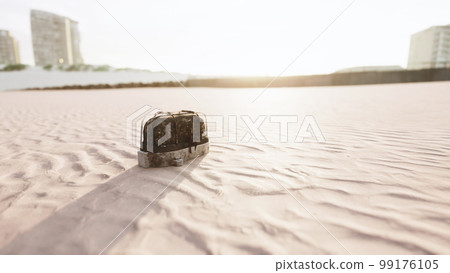 old rusted trash on the sand beach 99176105