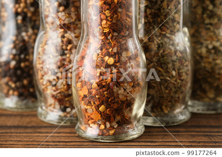 Mills of aromatic spices and herbs. Several grinders of different seasoning. Condiments for cooking. Mills of aromatic spices and herbs. Several grinders of different seasoning. Condiments for cooking. 99177264