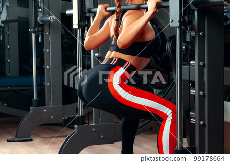 Slim girl working out in training apparatus 99178664