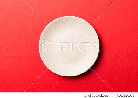 Top view of isolated of colored background empty round beige plate for food. Empty dish with space for your design Top view of isolated of colored background empty round beige plate for food. Empty dish with space for your design 99180105