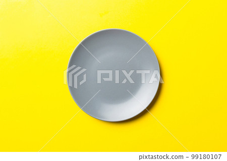 Top view of isolated of colored background empty round gray plate for food. Empty dish with space for your design Top view of isolated of colored background empty round gray plate for food. Empty dish with space for your design 99180107