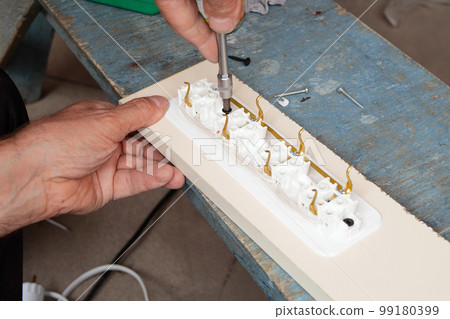 man making an extension cord socket outdoor man making an extension cord socket outdoor 99180399