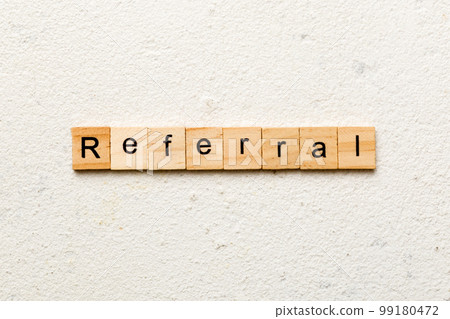 Referral word written on wood block. Referral text on cement table for your desing, Top view concept 99180472