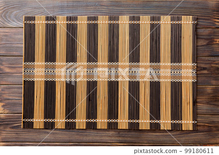 Top view of brown tablecloth for food on wooden background. Empty space for your design Top view of brown tablecloth for food on wooden background. Empty space for your design 99180611