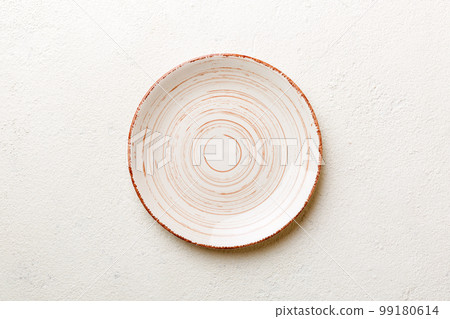 Top view of empty colorful plate on cement background. Empty space for your design Top view of empty colorful plate on cement background. Empty space for your design 99180614