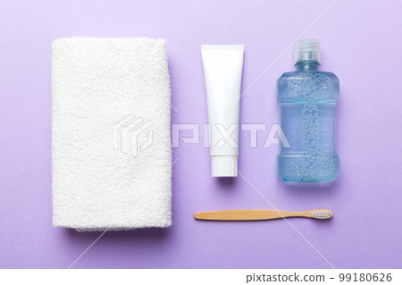 Mouthwash and other oral hygiene products on colored table top view with copy space. Flat lay. Dental hygiene. Oral care products and space for text on light background. concept 99180626