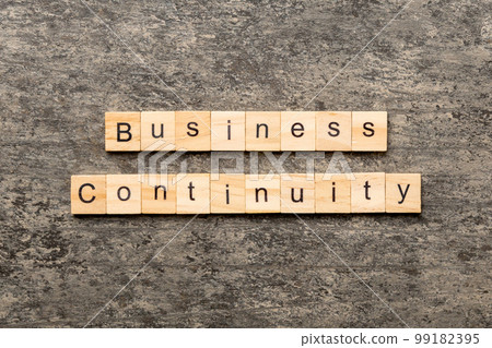 Business Continuity word written on wood block. Business Continuity text on cement table for your desing, concept 99182395