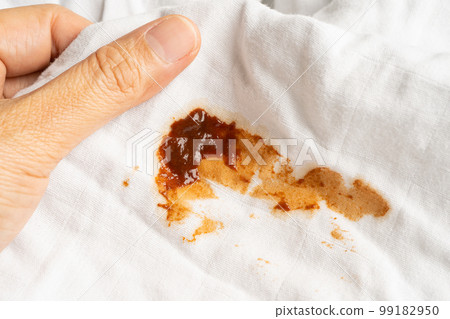 Dirty tomato sauce stain or ketchup on cloth to wash with washing powder, cleaning housework concept. 99182950