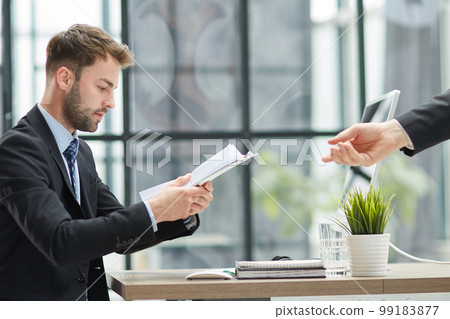 Close Up Of Businessman Taking Folders From Hand Close Up Of Businessman Taking Folders From Hand 99183877