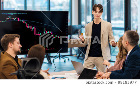 Young worker leading business meeting about cryptocurrencies in an office Young worker leading business meeting about cryptocurrencies in an office 99183977